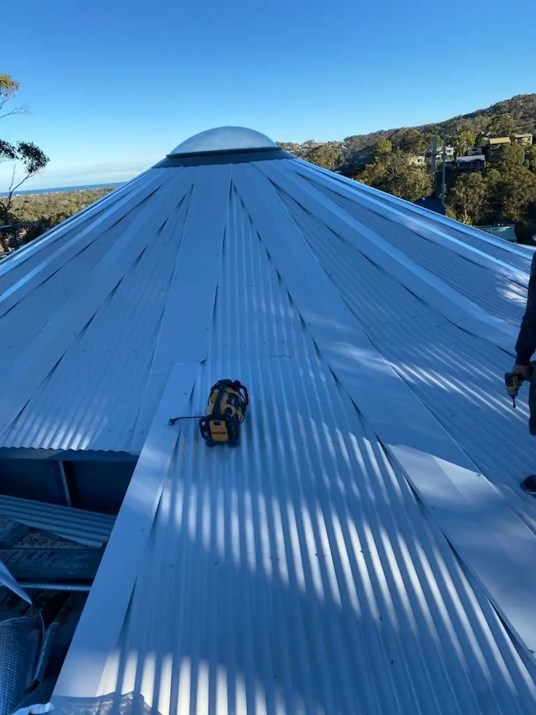 Octagonal metal roof rising to a round dome skylight