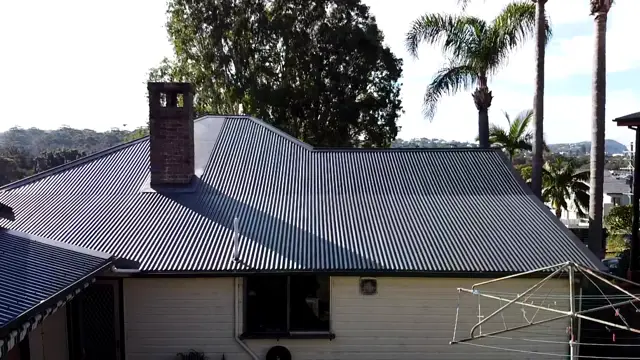 Terrigal home with a new Colorbond Monument metal roof and a brick chimney