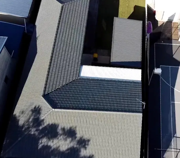 Aerial view of a concrete tile roof in Terrigal restored and coated in Colorbond Woodland Grey