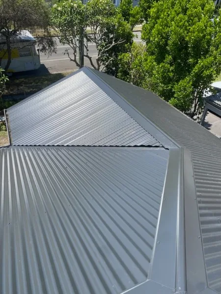 Newly installed Zincalume corrugated metal roof — ridge detail — Roof Restorations & Replacements Central Coast